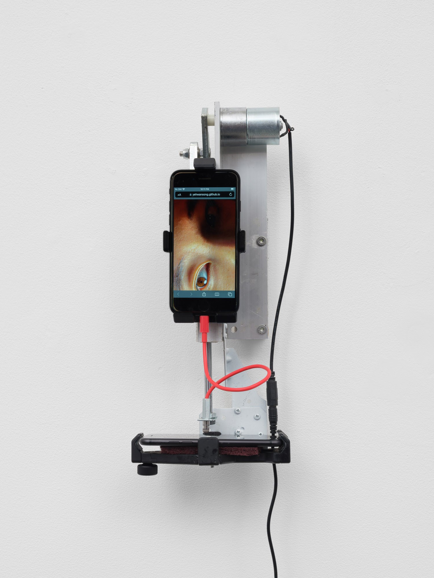 Yehwan Song, Witnessing, 2026 Two phone, divere materials, 38 × 18 × 12 cm