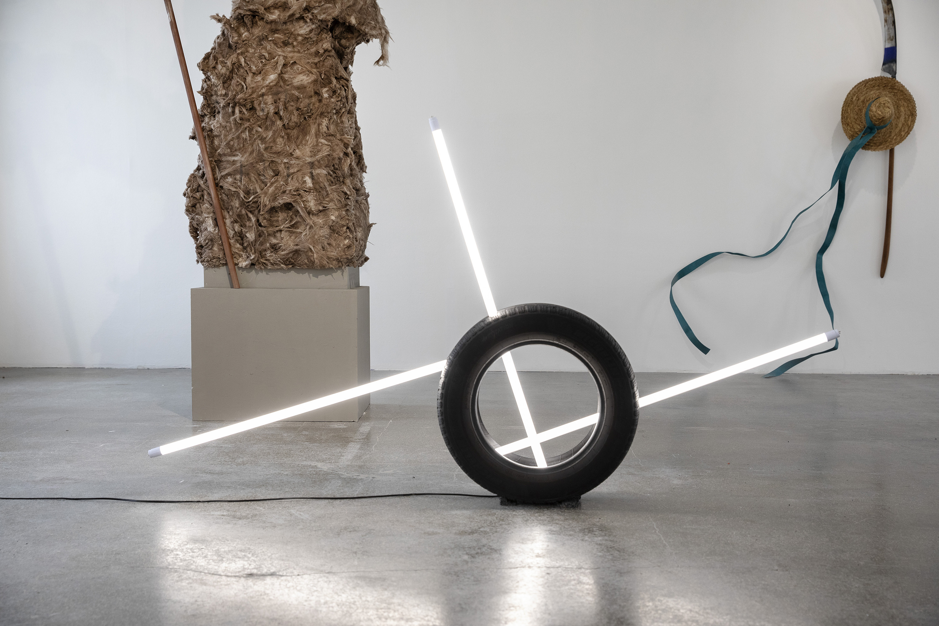 Exhibition view with Vasco Costa's Driven by Numbers, 2025 Car tyres, LED neon tubes Each 120 × 60 × 60 cm