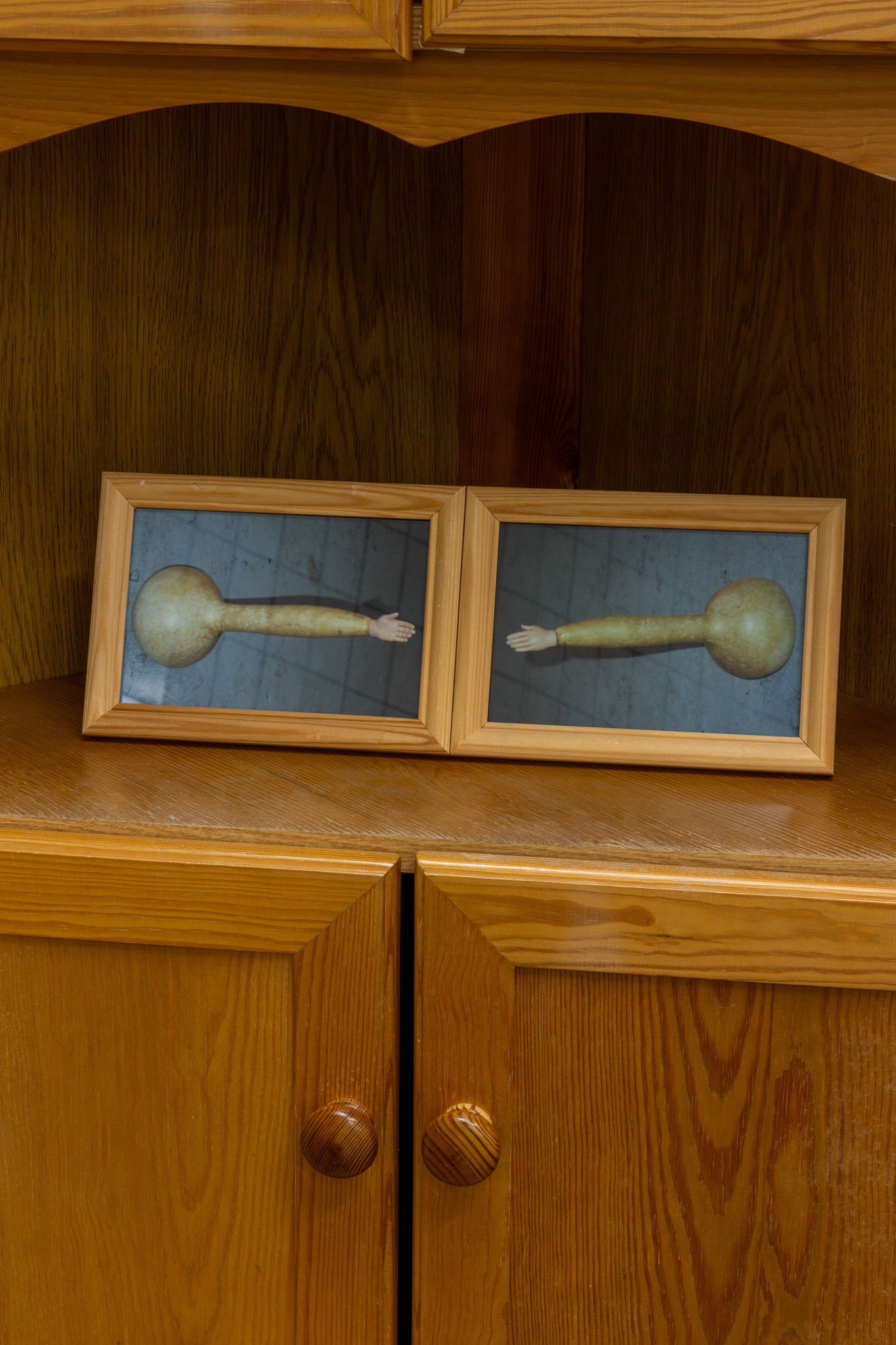 Hertta Kiiski & Janne Punkari: Kuin taivasta koskettaisi (As If Touching the Sky), 2025, cabinet, squash, clogs, handle, chromogenic photographs in wooden frames, mirror frame with pigment print on aluminium, 179 x 81 x 40 cm