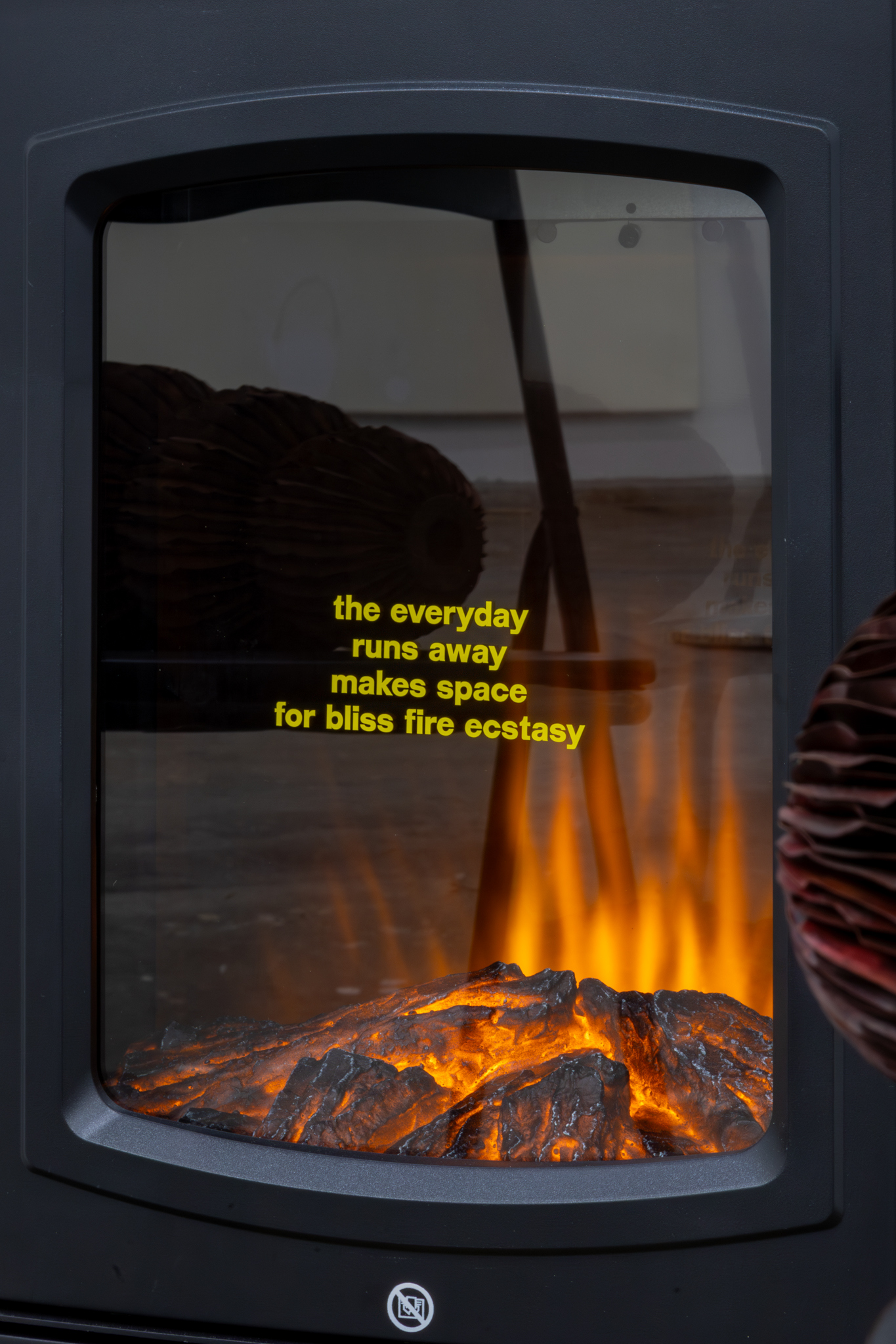 Roos Hermsen: Commissioned poem (fragment), 2026, electric fireplace, vinyl sticker, birch firewood logs, 77 x 44 x 32 cm
