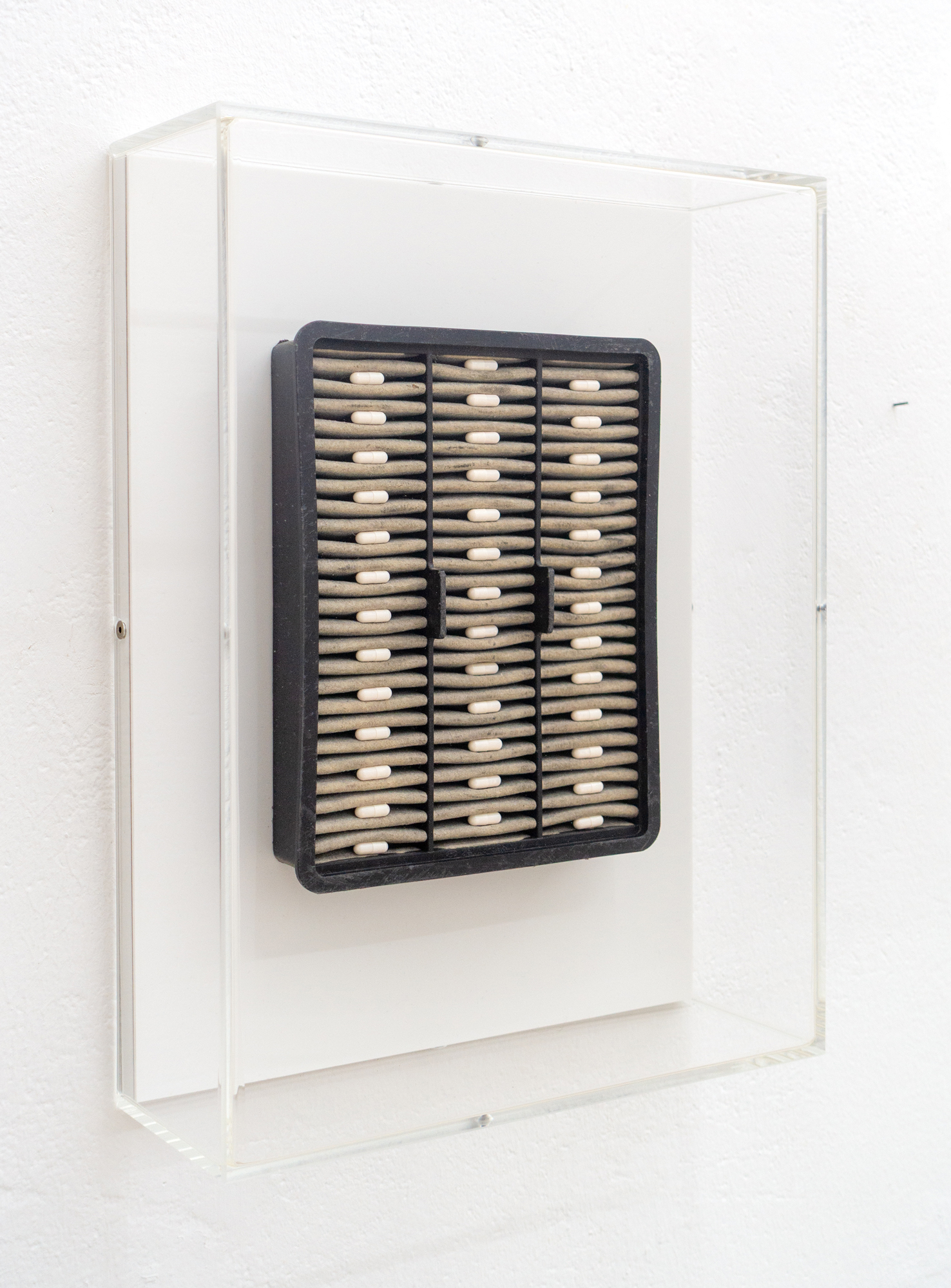 Kurt von Bley · Self portrait, pt. 2 · Used air filter, tablets, MDF, acrylic glass · 30 × 40 × 10 cm · 2014