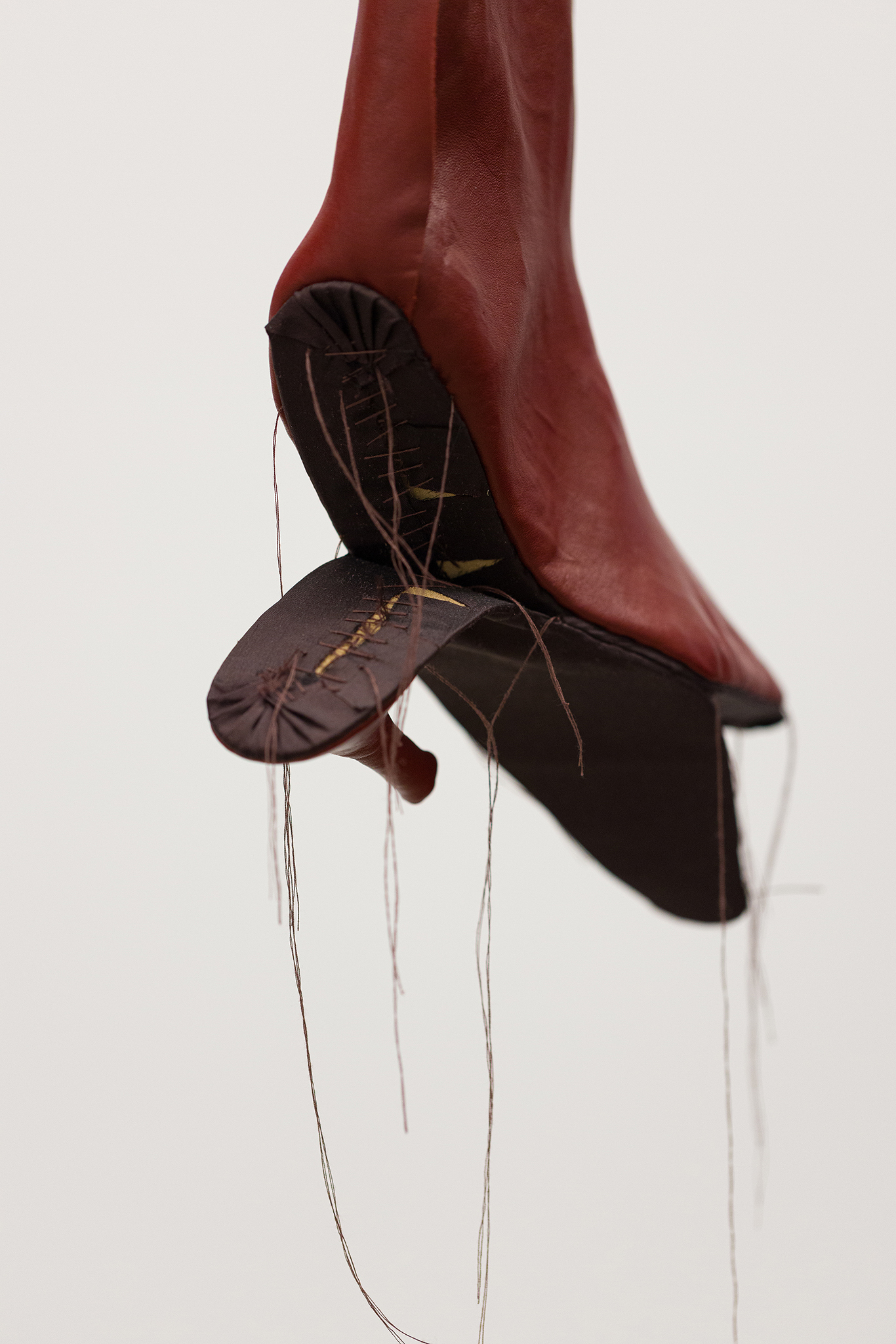 detail of Spitting, 2026 - leather, silk, thread, horse hair, mat board, aluminum
