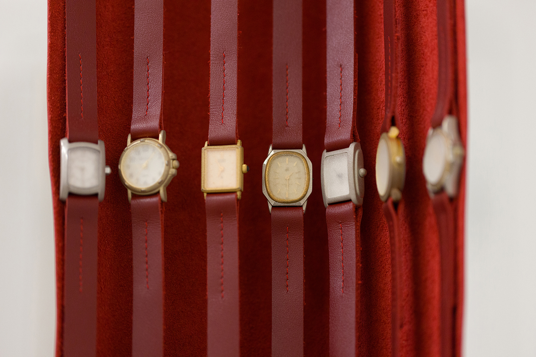 detail of Hands, 2025 - leather, sandblasted watch faces, watch buckles, aluminum