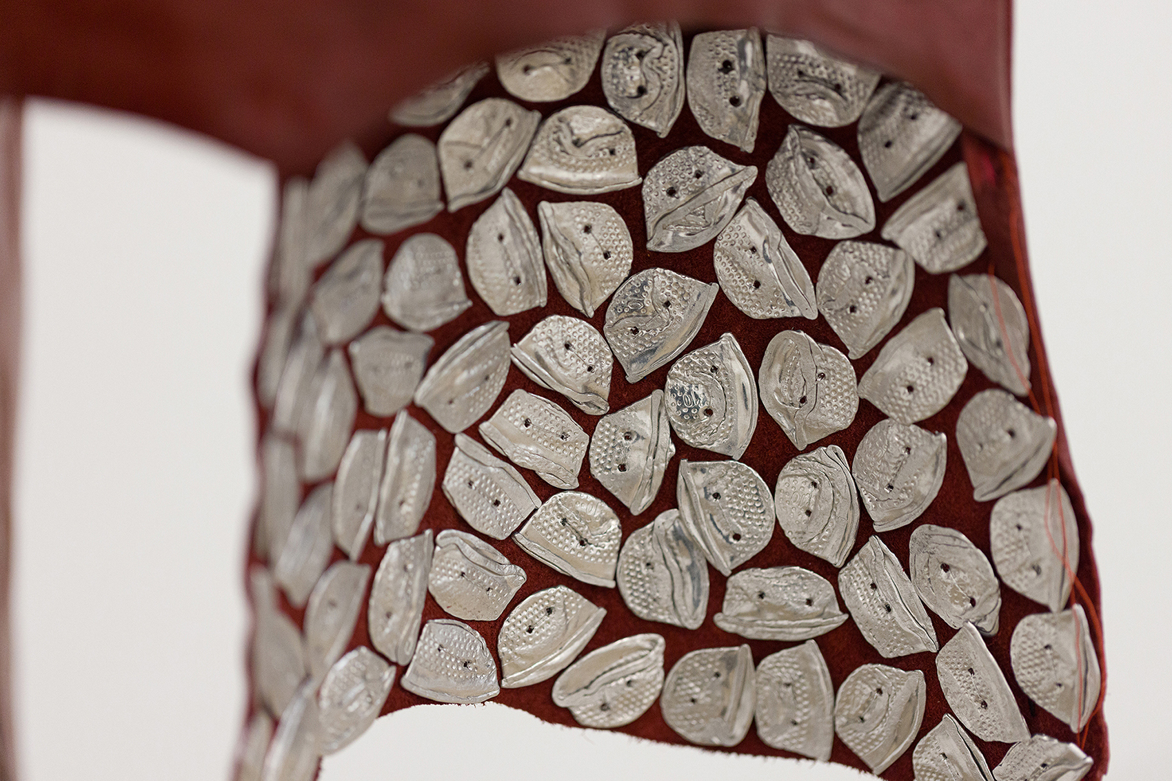 detail of Caress, 2026 - leather, silk, thread, hammered thimbles, horse hair, mat board, aluminum