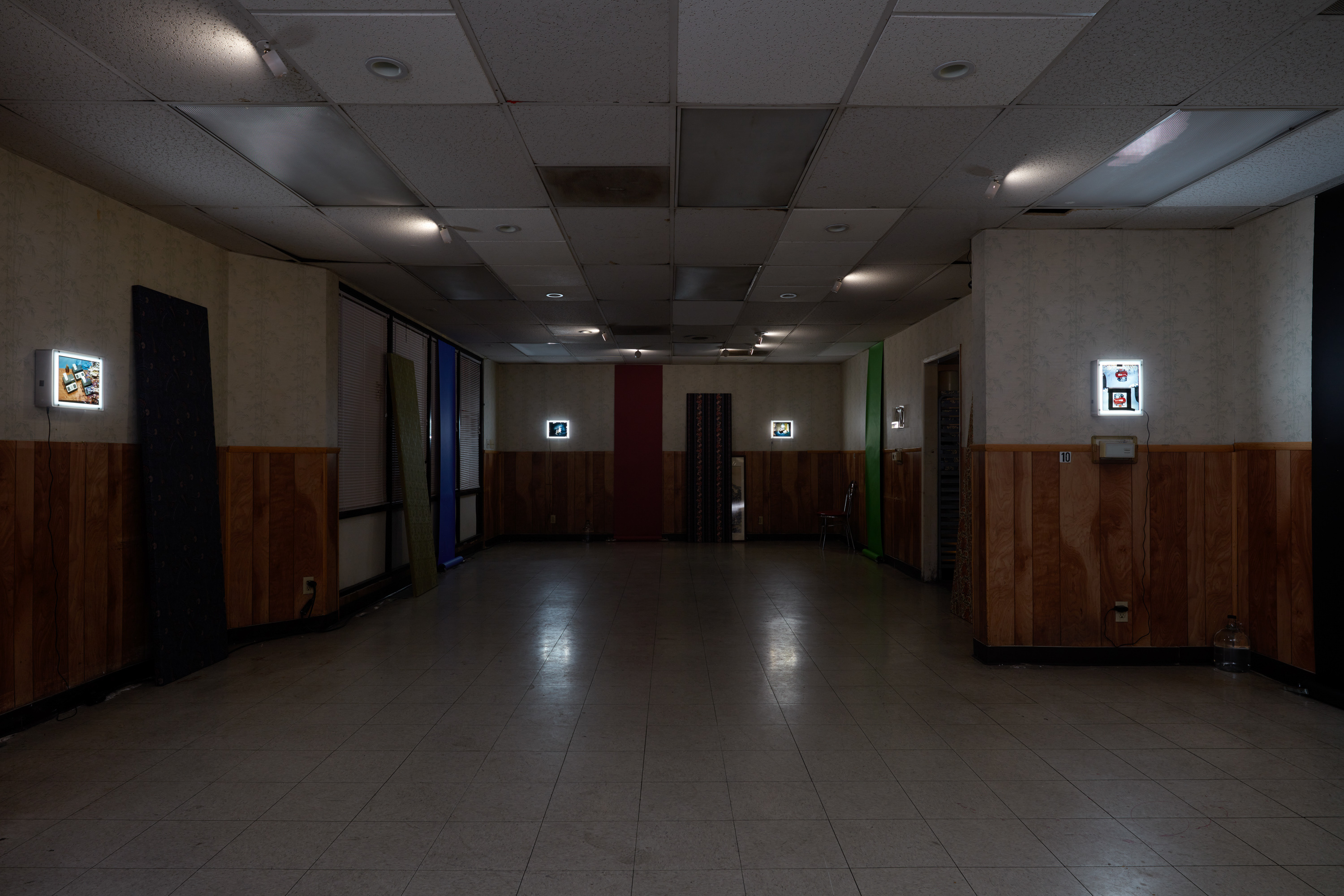 Laurel M. Ross, damaged silver gelatin prints circa 1982, acrylic boxes / Ruyell Ho, damaged 8x10 inch transparencies from Communigrafix, Chicago, circa 1982, acrylic, lightboxes / Doors, fabrics, background paper, tacks, clamps, safelights, jugs, water