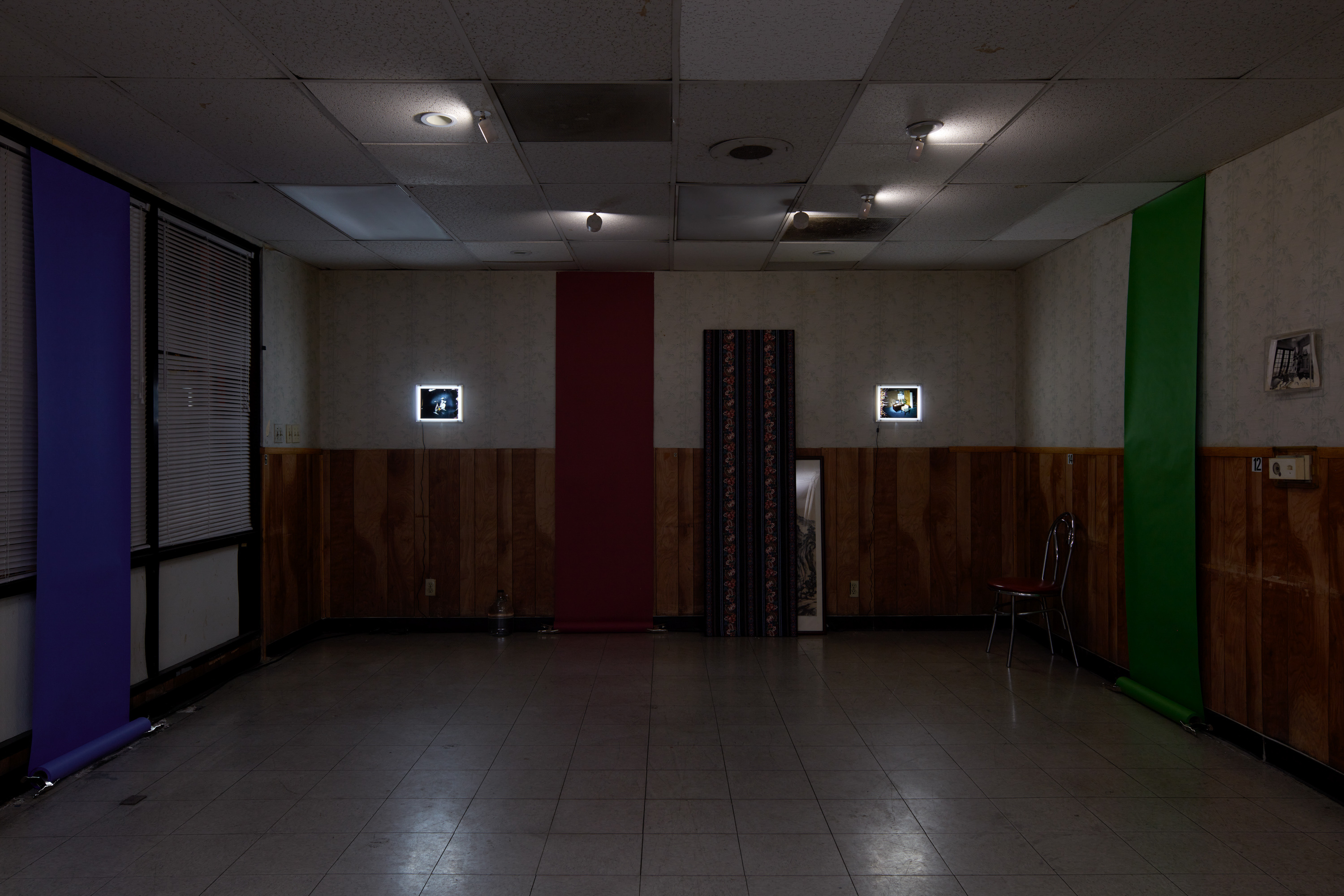 Laurel M. Ross, damaged silver gelatin prints circa 1982, acrylic boxes / Ruyell Ho, damaged 8x10 inch transparencies from Communigrafix, Chicago, circa 1982, acrylic, lightboxes / Doors, fabrics, background paper, tacks, clamps, safelights, jugs, water