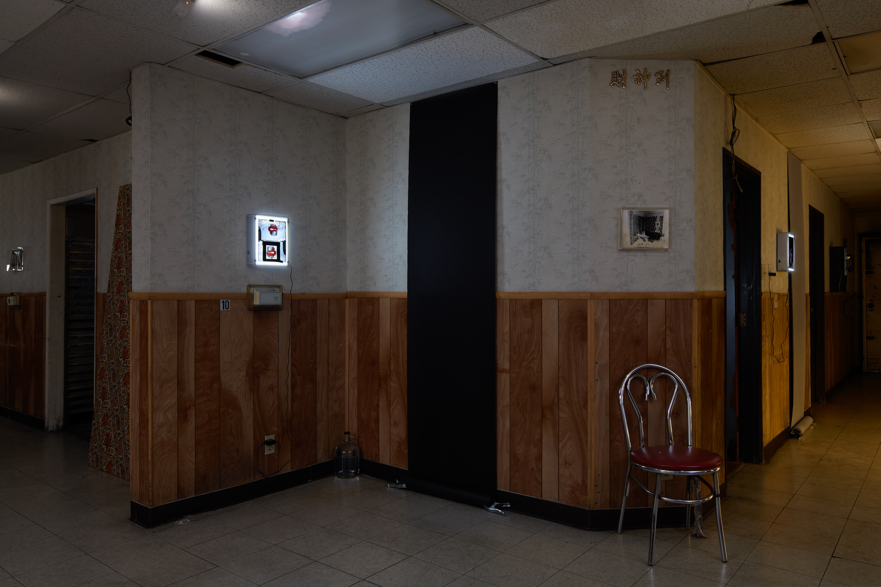 Laurel M. Ross, damaged silver gelatin prints circa 1982, acrylic boxes / Ruyell Ho, damaged 8x10 inch transparencies from Communigrafix, Chicago, circa 1982, acrylic, lightboxes / Doors, fabrics, background paper, tacks, clamps, safelights, jugs, water