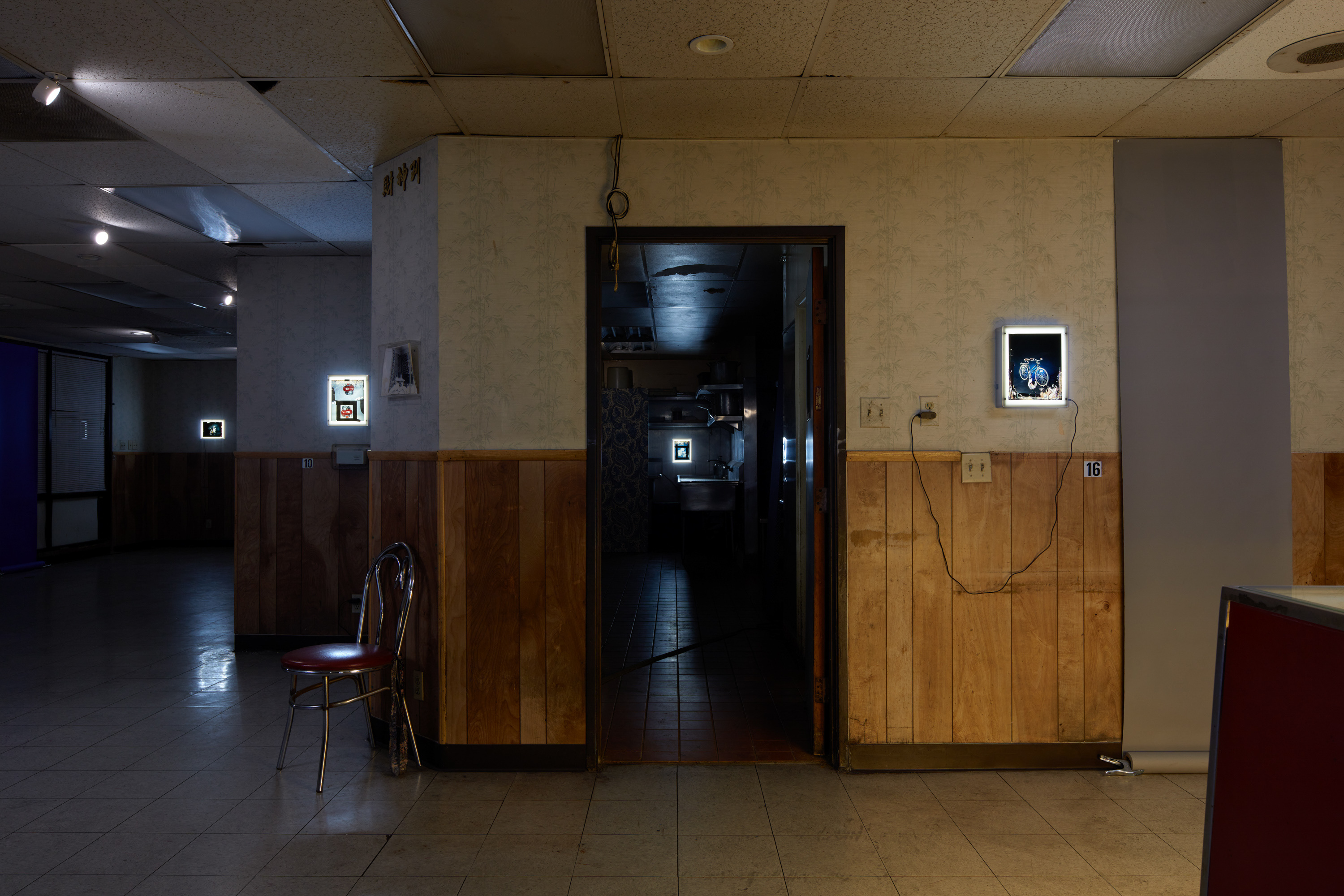 Laurel M. Ross, damaged silver gelatin prints circa 1982, acrylic boxes / Ruyell Ho, damaged 8x10 inch transparencies from Communigrafix, Chicago, circa 1982, acrylic, lightboxes / Doors, fabrics, background paper, tacks, clamps, safelights, jugs, water