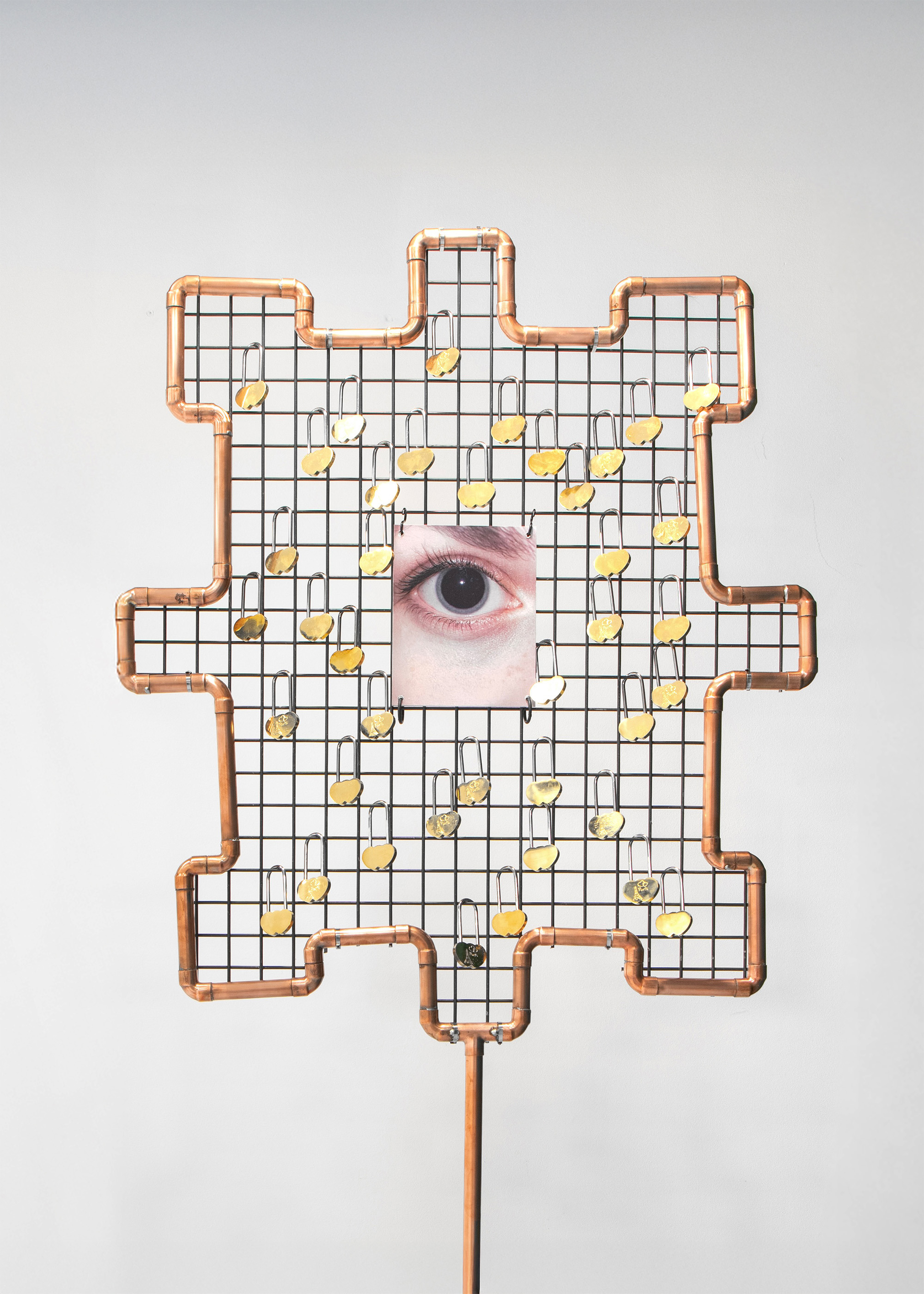 Misha Gudwin, Lock eyes, 2026, 214 x 85 x 85 cm, copper, steel, locks, printing on dibond