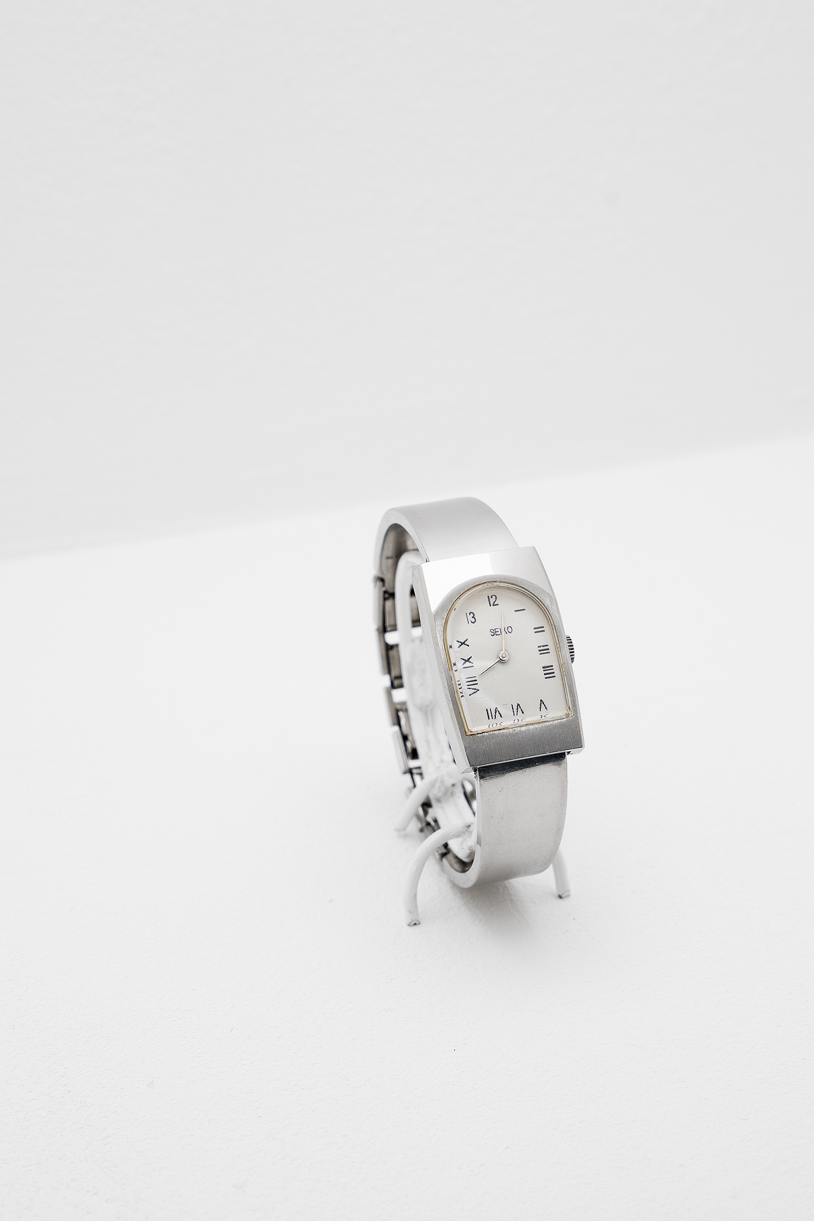 Daniel Stubenvoll, conversation starter (my left hands dream of time for us all), ca. 1980/2026, Vintage Seiko Unisex Watch, Steel Case, Custom Enamel Painted Dial, 22 x 26 mm, Manual Wind, Original Steel Stretch Bracelet