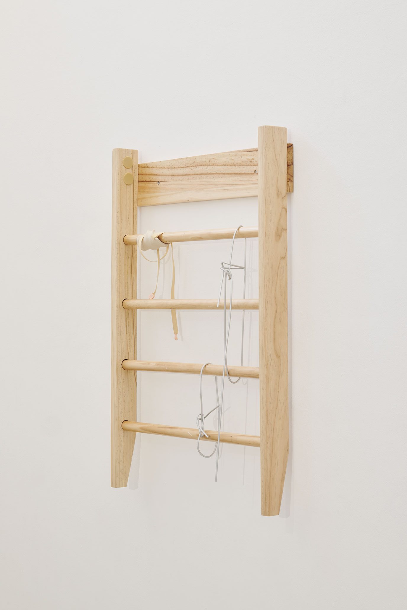 Flop (2025), wall bars, ceramic, aluminum bar, elastic band, cord ends