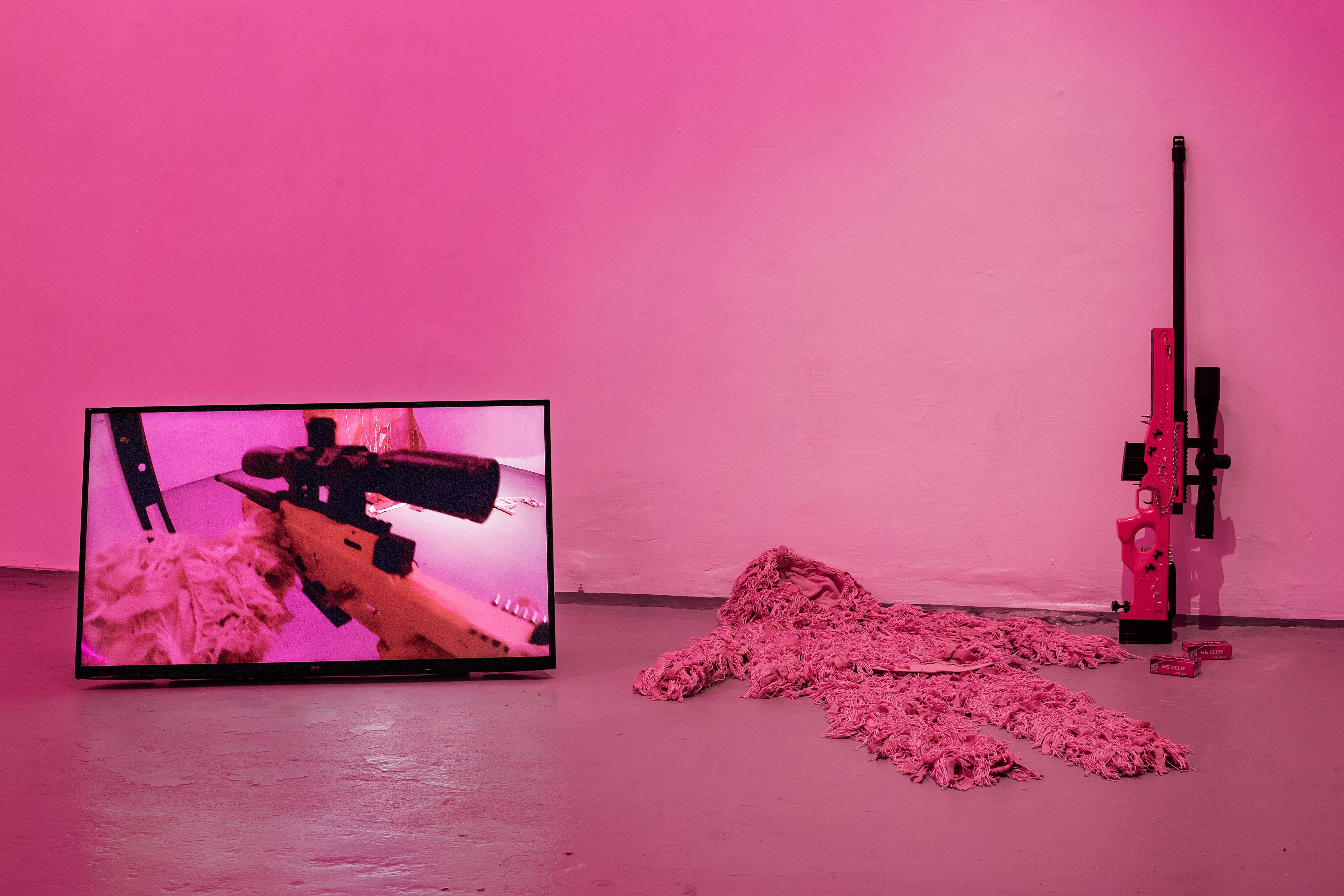Keiu Maasik, Will I Die a Violent Death?, 2026. Spatial installation (plaster, metal, polyurethanene foam, ghillie suits, decorated 3D-printed weapon models and airsoft guns, redesigned cartridge boxes, used parachute canopy, video with sound). 