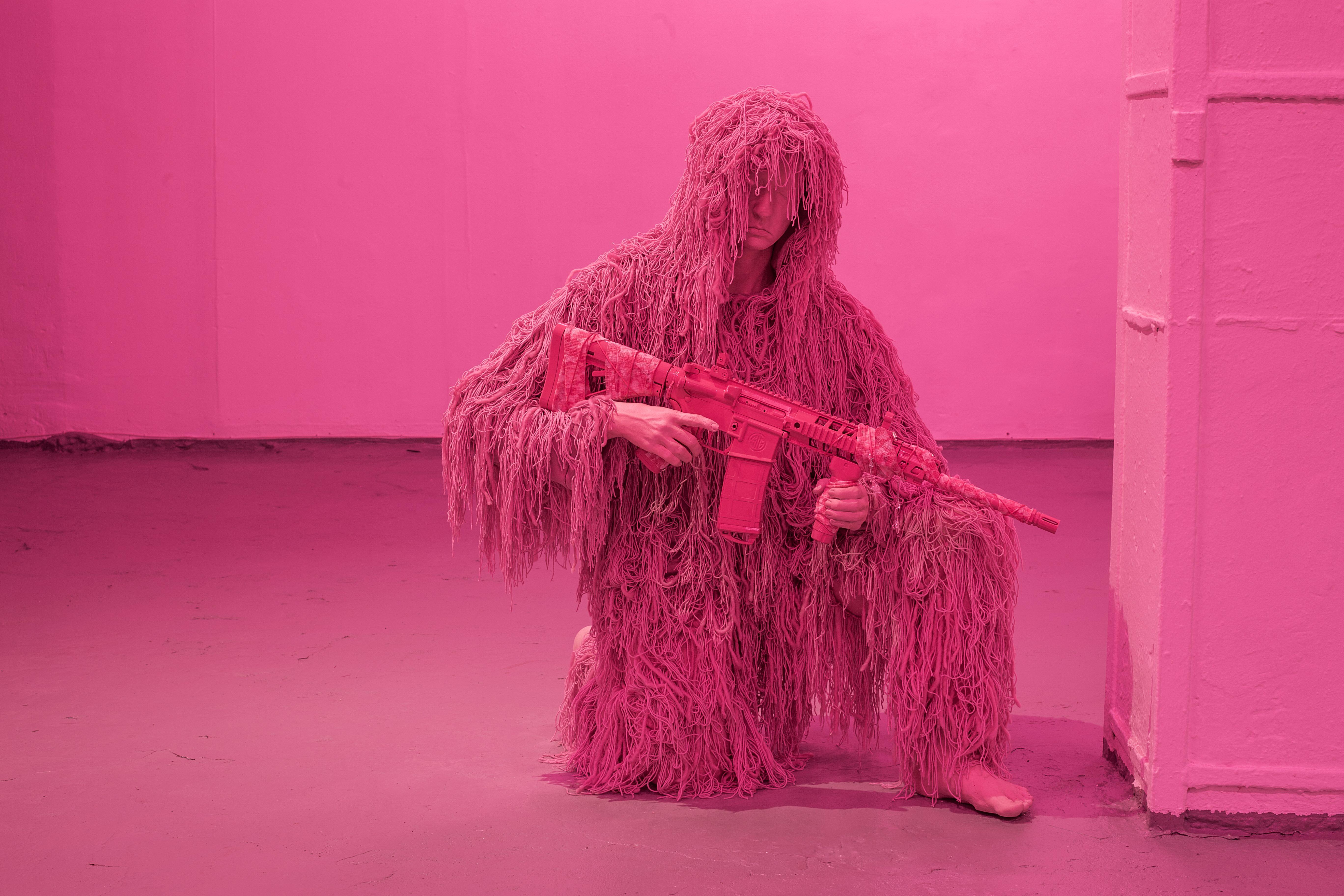 Keiu Maasik, Will I Die a Violent Death?, 2026. Spatial installation (plaster, metal, polyurethanene foam, ghillie suits, decorated 3D-printed weapon models and airsoft guns, redesigned cartridge boxes, used parachute canopy, video with sound). 