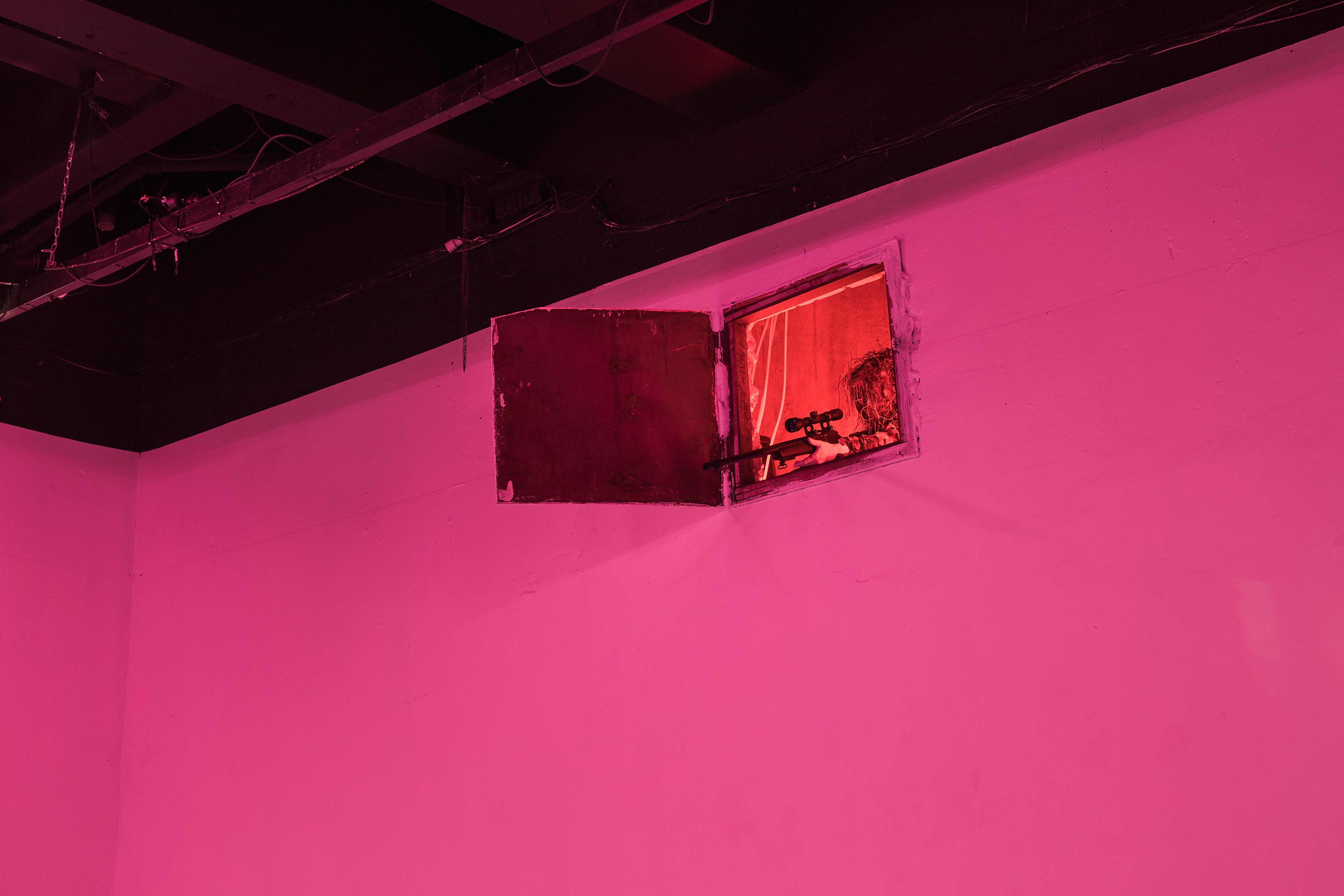 Keiu Maasik, Will I Die a Violent Death?, 2026. Spatial installation (plaster, metal, polyurethanene foam, ghillie suits, decorated 3D-printed weapon models and airsoft guns, redesigned cartridge boxes, used parachute canopy, video with sound). 