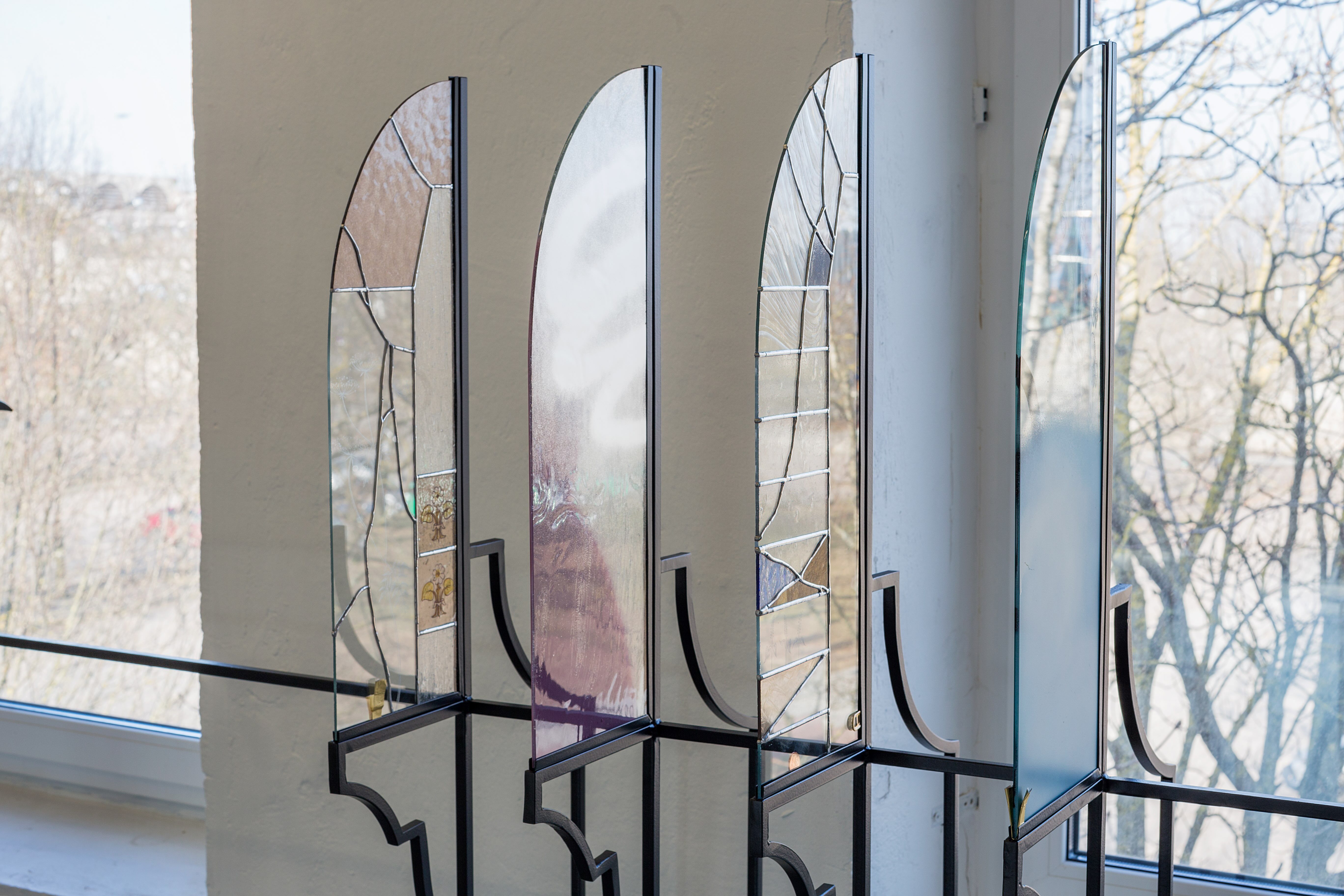 Anna Mari Liivrand, Amid Bitter Flowers, 2026. Installation (wrought iron, stained glass, antique glass, found glass, solder, spray paint, coins, buttons and ohter found objects).