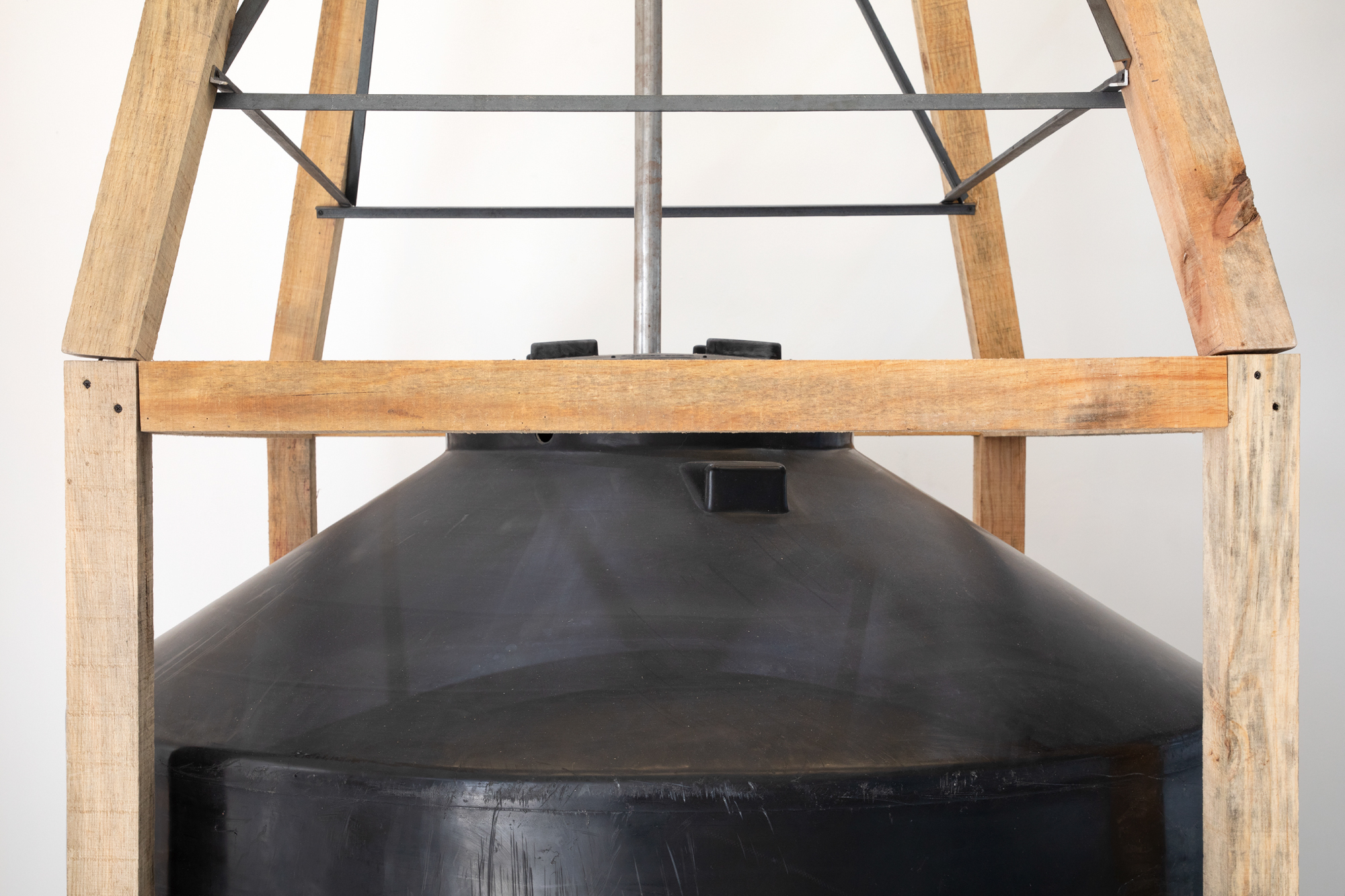OSCAR TUAZON Sovereign Citizen, 2026 Water tank, driftwood, aluminum and steel 157 x 157 x 520 cm 61.8 x 61.8 x 204.7 in