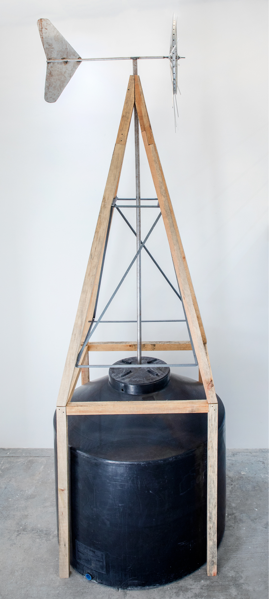 OSCAR TUAZON Sovereign Citizen, 2026 Water tank, driftwood, aluminum and steel 157 x 157 x 520 cm 61.8 x 61.8 x 204.7 in