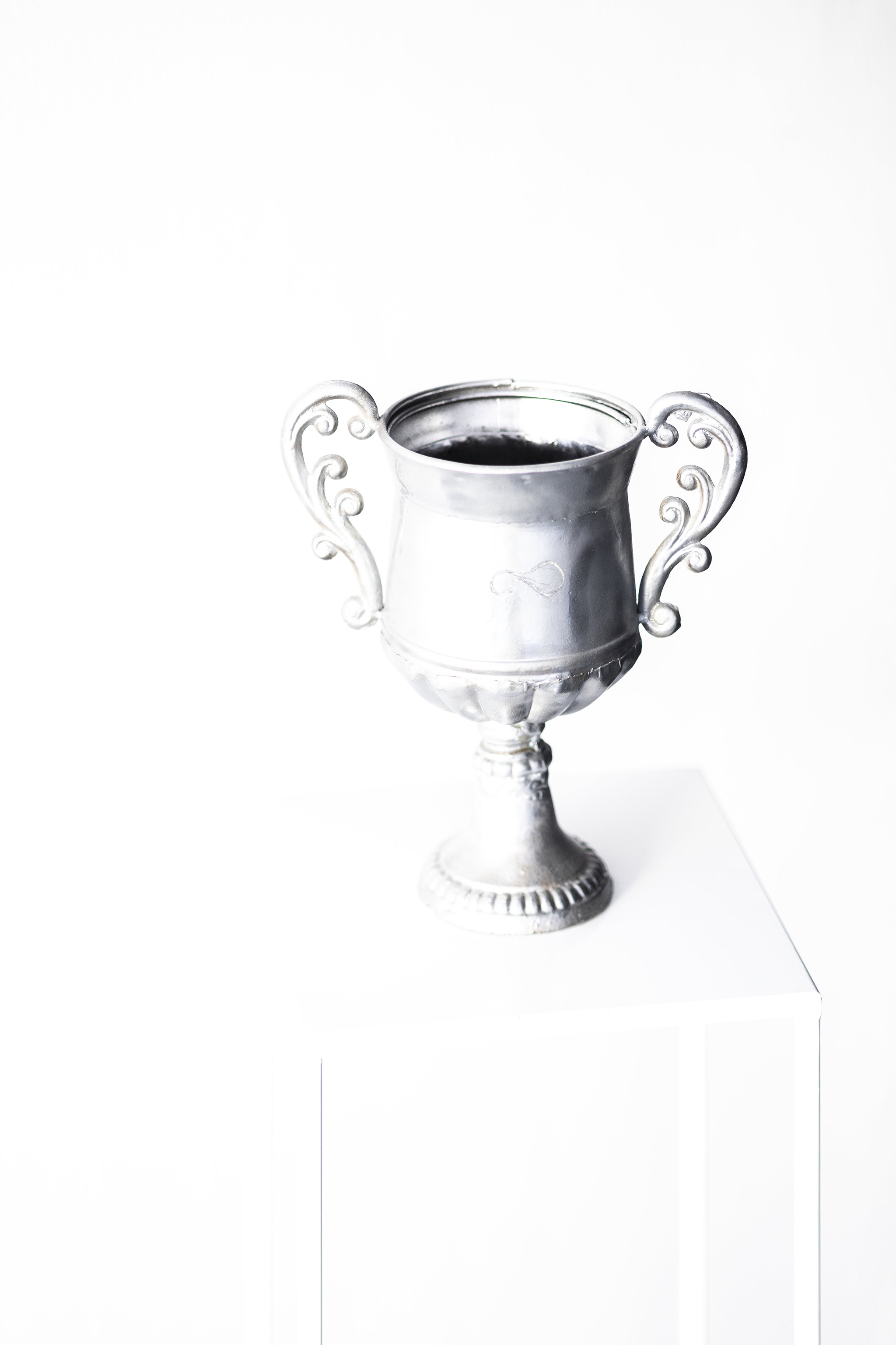 ﻿∞, object: metal urn, chrome paint, engraving, glass, QR code with online content,  32 x 28 cm, 2025