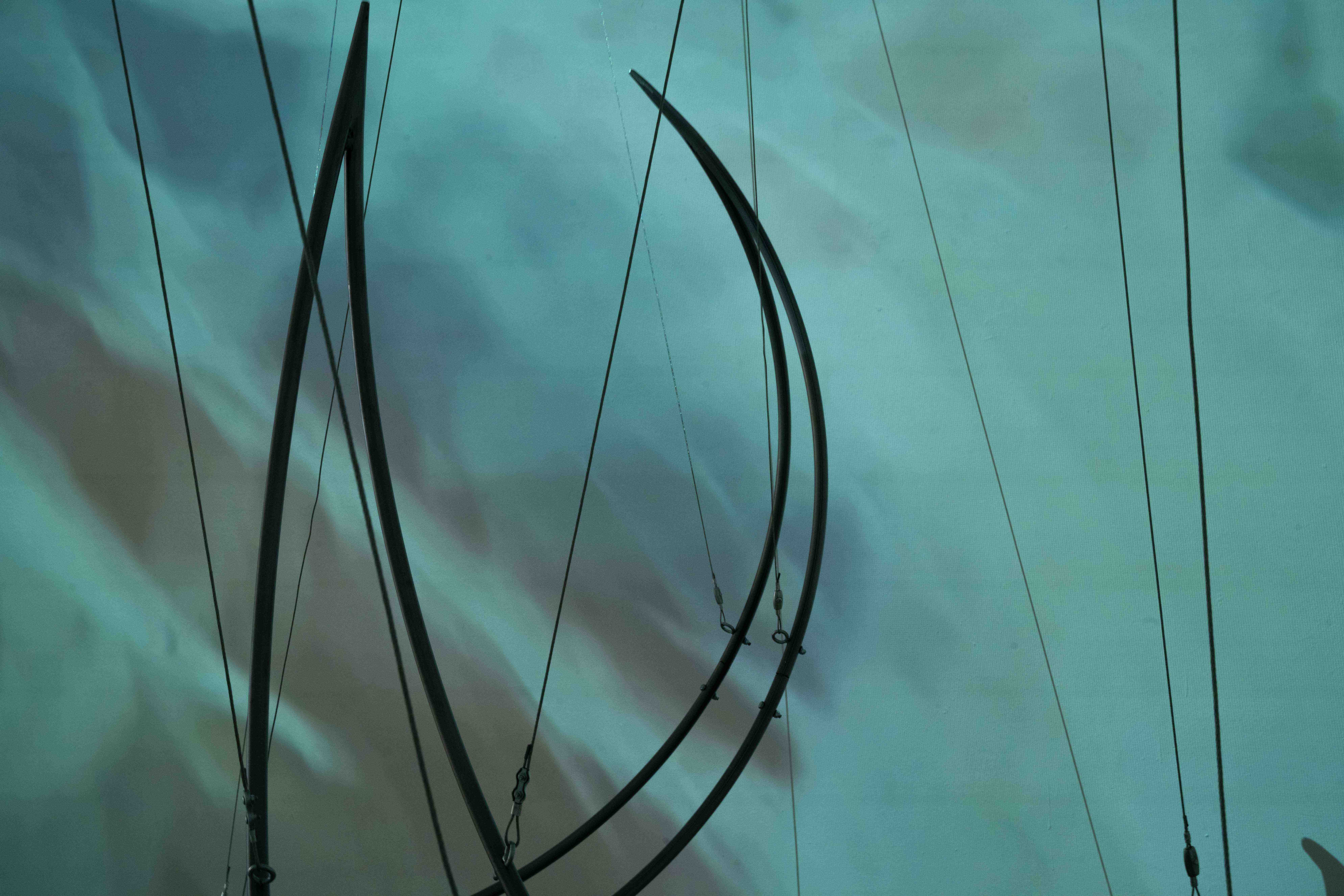 Agnes Questionmark, Exiled in Domestic Life. 2025. Single- channel video, Elena Rocabert, Balance Dependency. 2025 Curved iron, steel cable, metal couplings