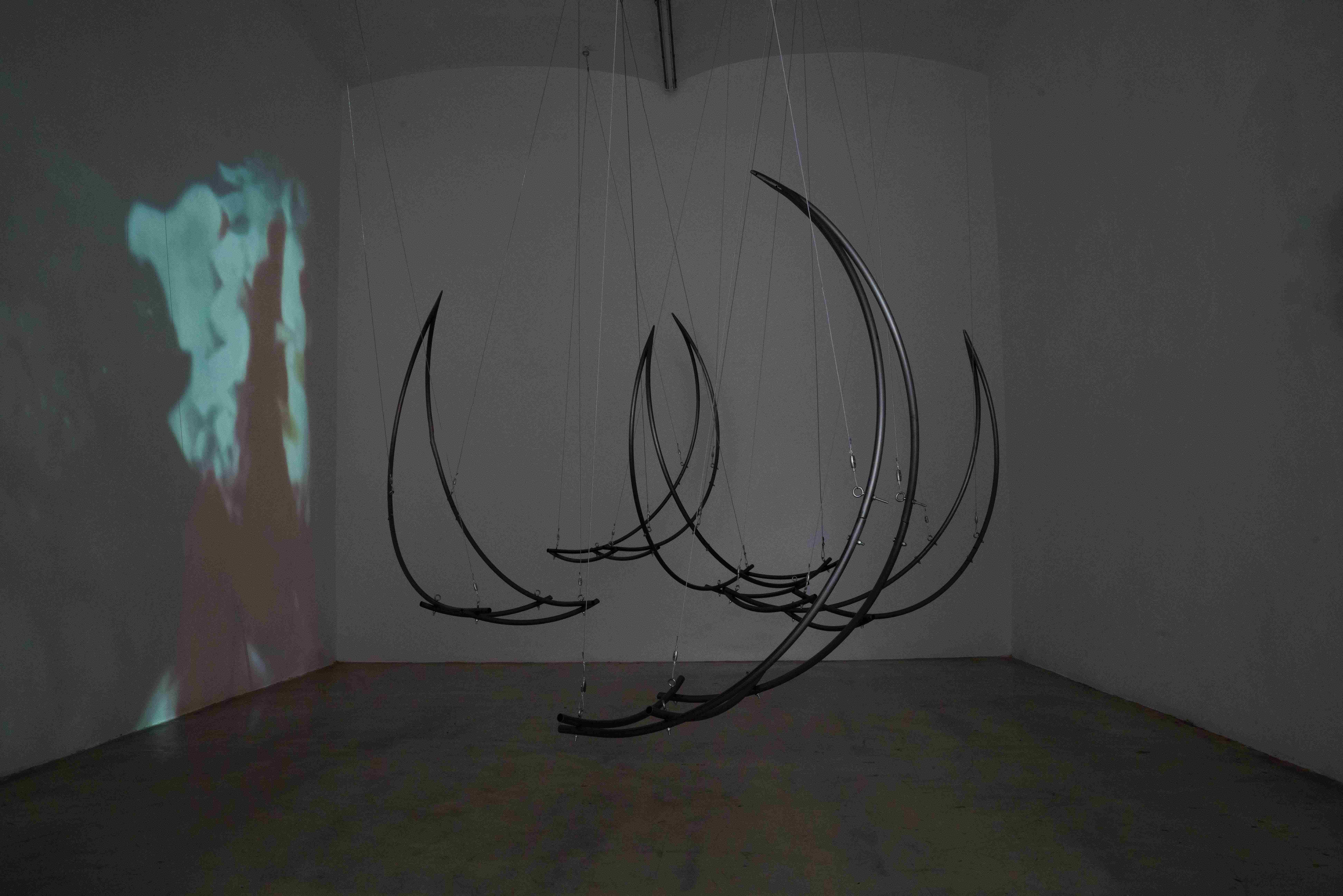 Elena Rocabert, Balance Dependency. 2025 Curved iron, steel cable, metal couplings