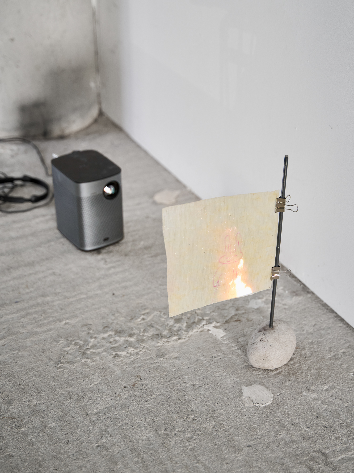 Charlotte Chapuis Soundiary, 2026 Videoloop, waxed paper, stone, metal, dimensions variable