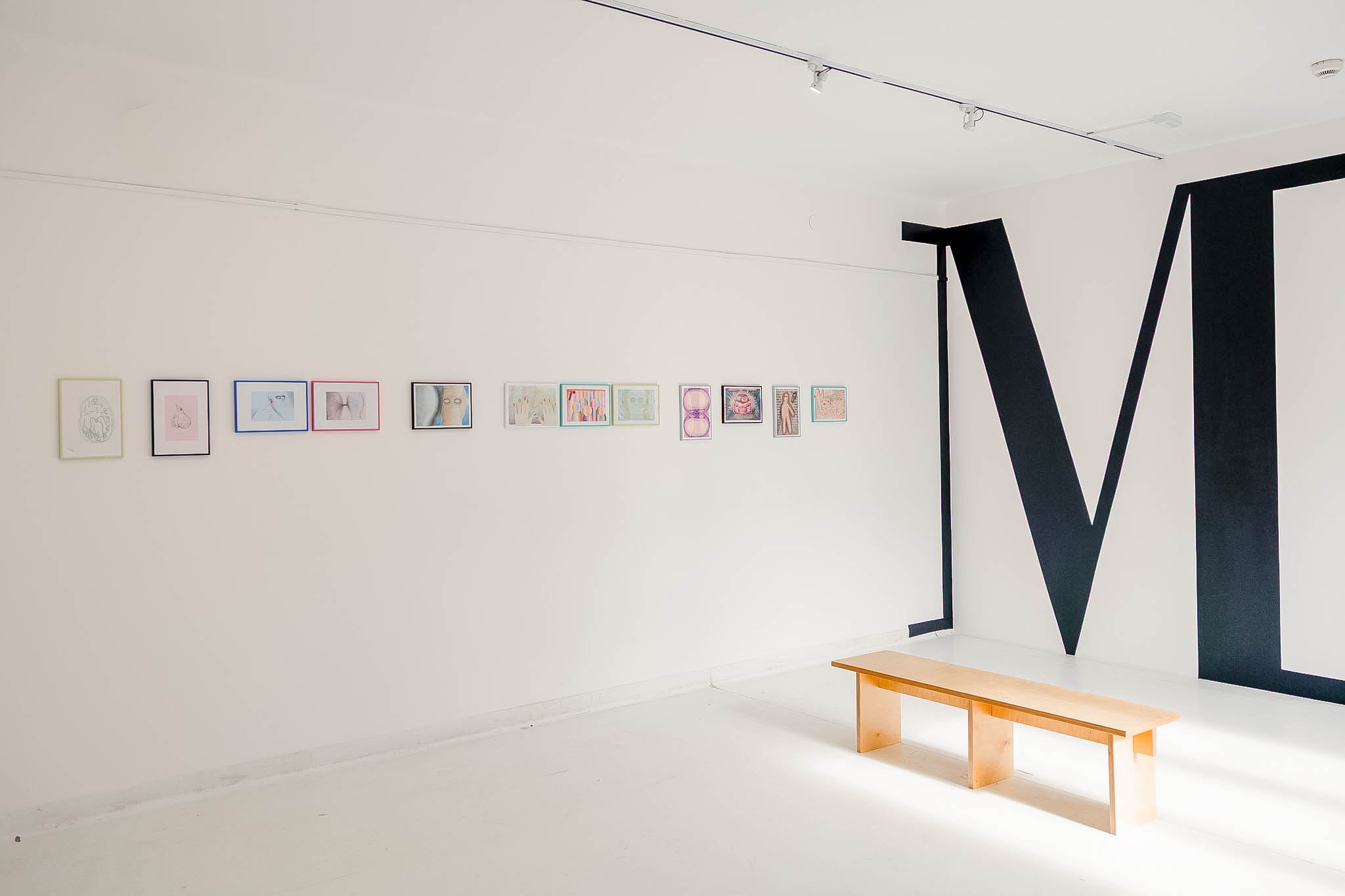 Drawings by Martyna Modzelewska and a mural depicting a giant letter M.