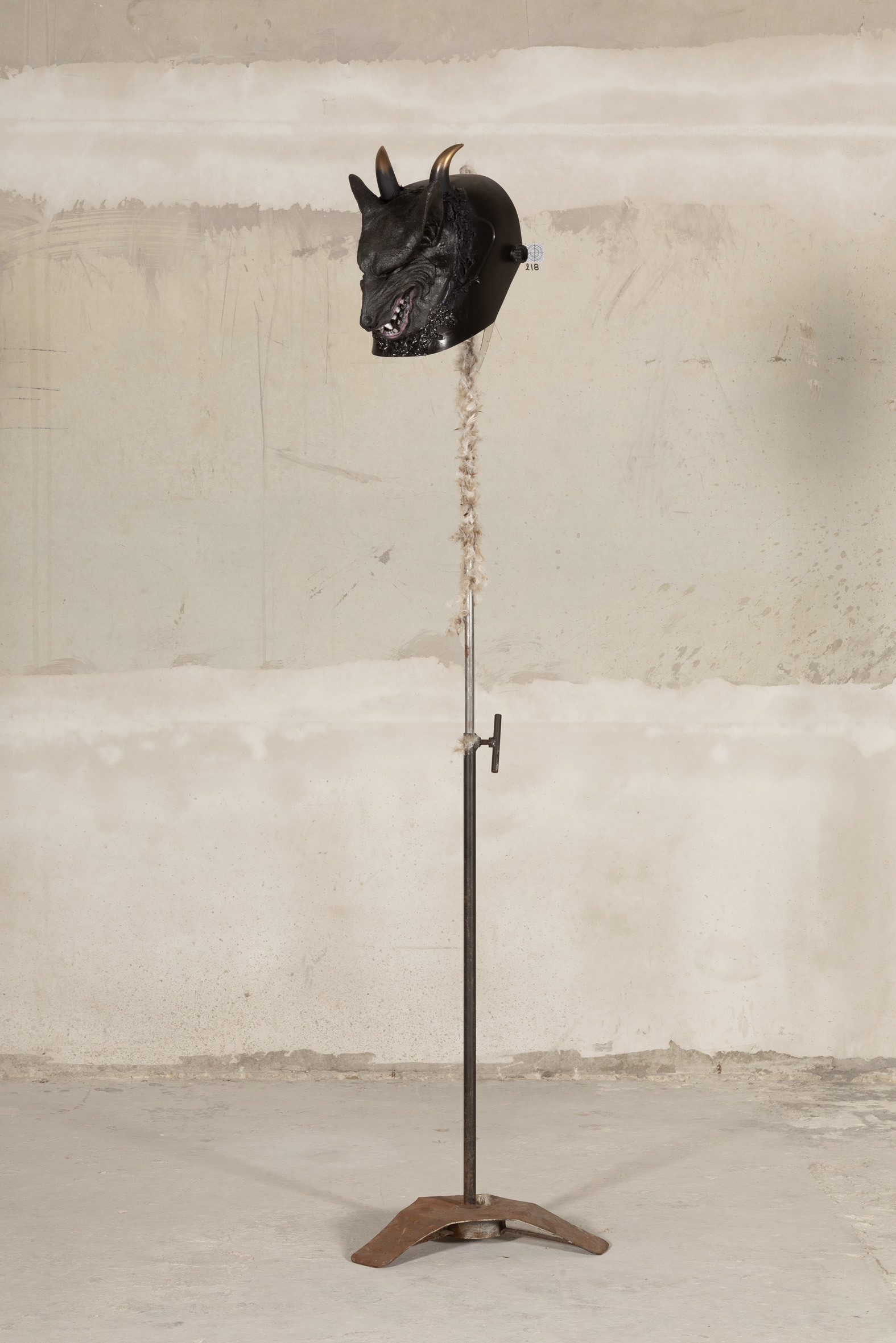 Ladji Diaby, 19/06/2024, 205, 2026, welding mask, dog mask, steel stand, goose feathers, aerosol, acrylic, 179 × 10 ×10 cm.
