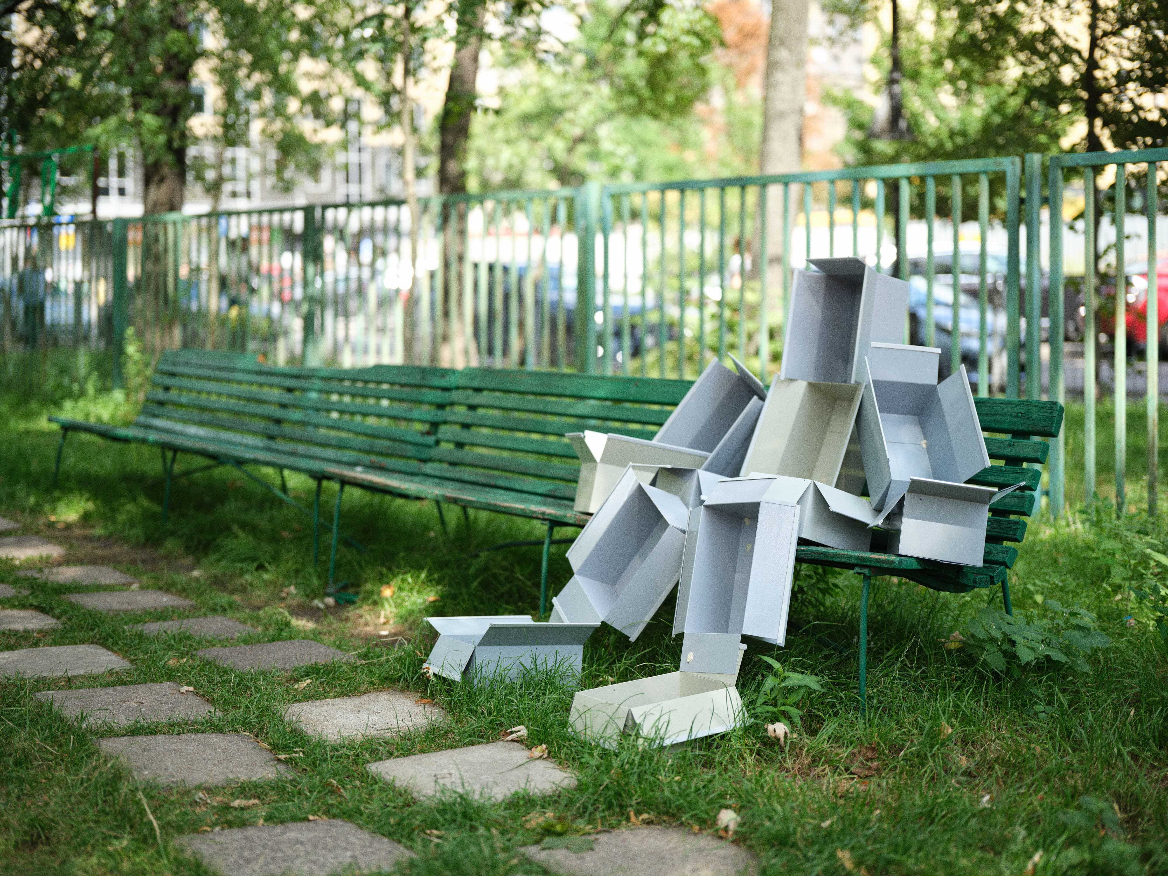 Piotrek Kowalski, _12 boxes_, 2026, painted steel, chewing gum, bench, 110 × 145 × 120 cm