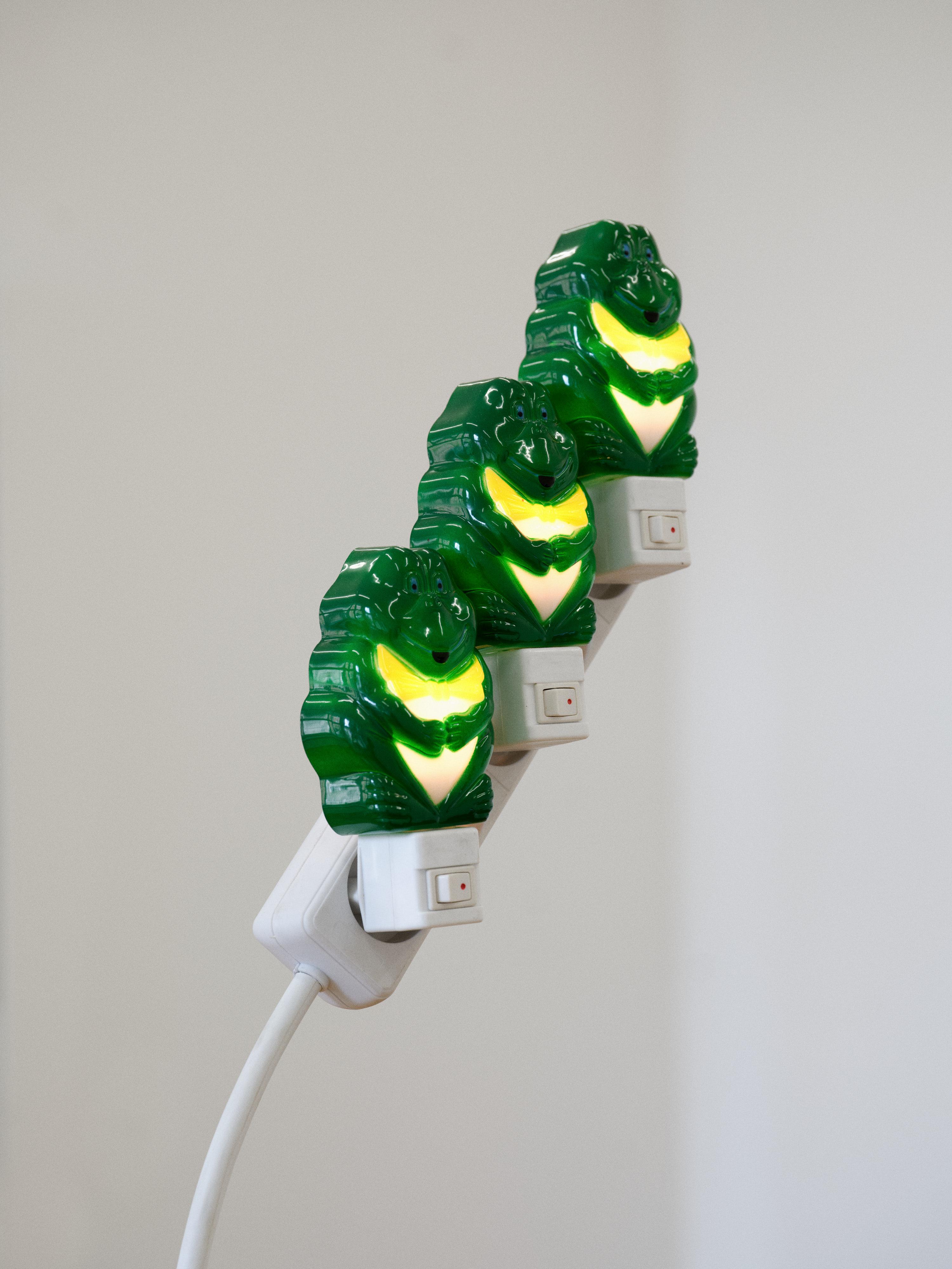 Piotrek Kowalski, _Triplets_, 2026, extension cord, stainless steel, plug-in lights, 190 × 80 × 80 cm