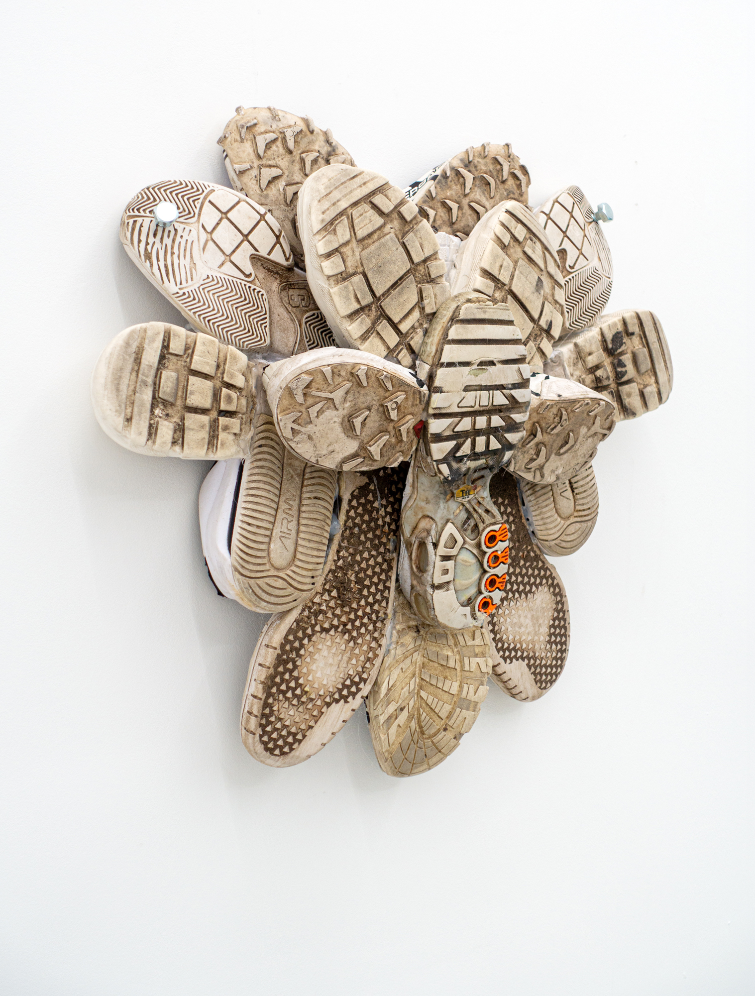 Mascha Naumann · grounded 1 · Sneaker soles & metal ·  57 × 52 × 17 cm · 2026