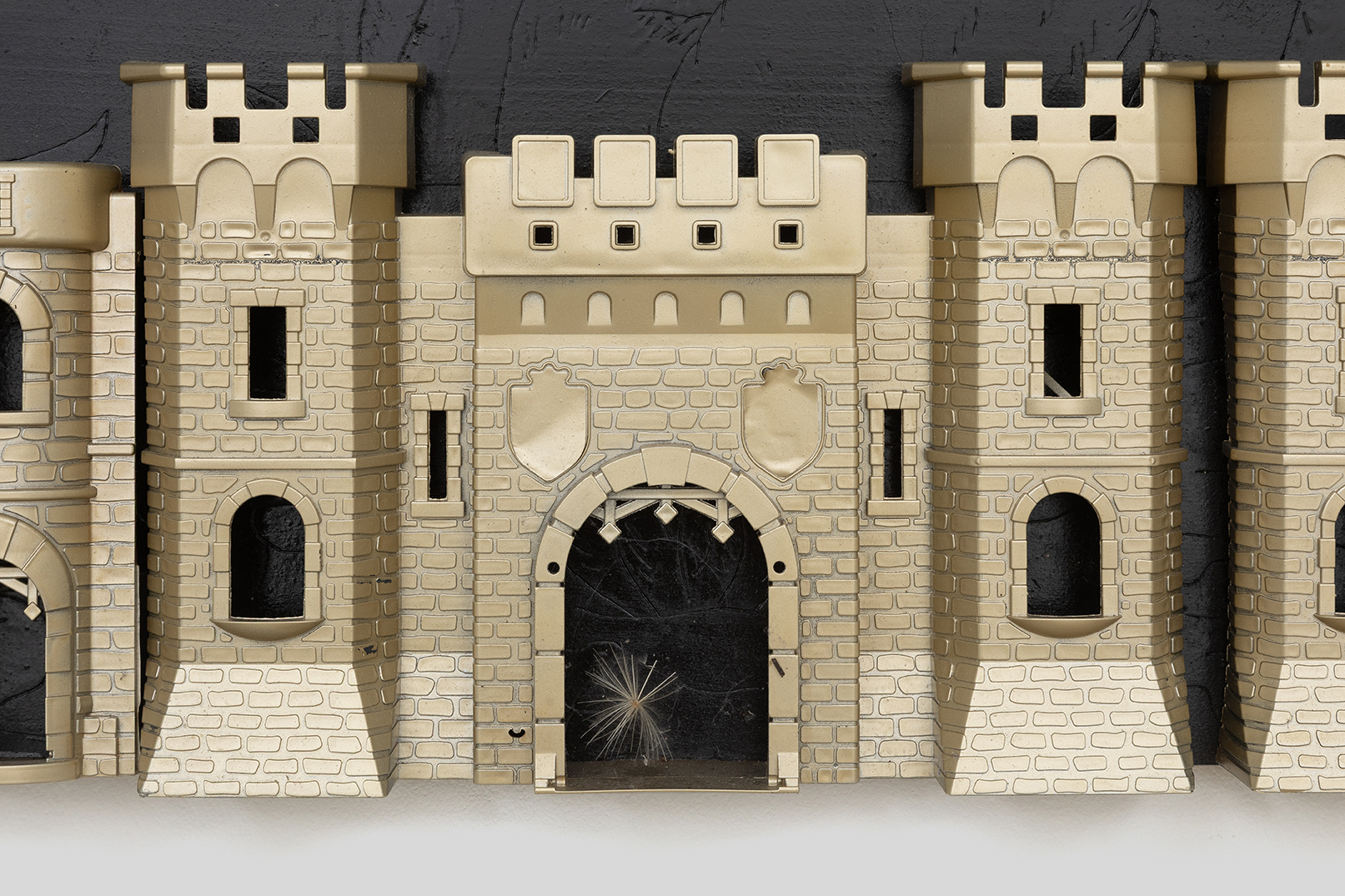 Ladji Diaby, Gatekeepers, 2026 (detail), Toy, laser print, wooden panel, aerosol spray, 49 × 131 × 7 cm.