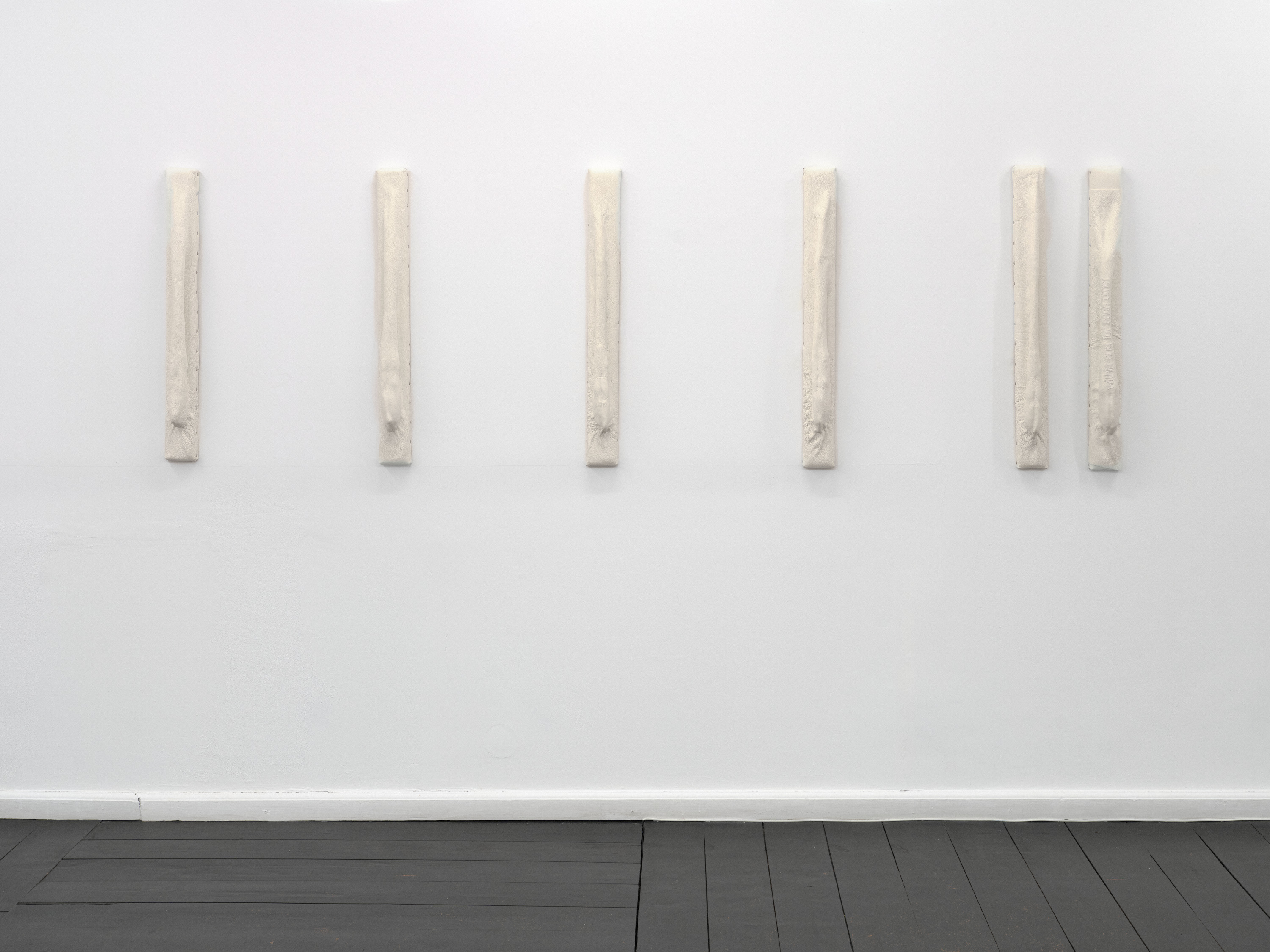 Relief 04 I–VI (2026). Pine Wood, Upholstery Foam, Recycled Leather, White Lacquer. 10 x 5 x 75 cm (each).