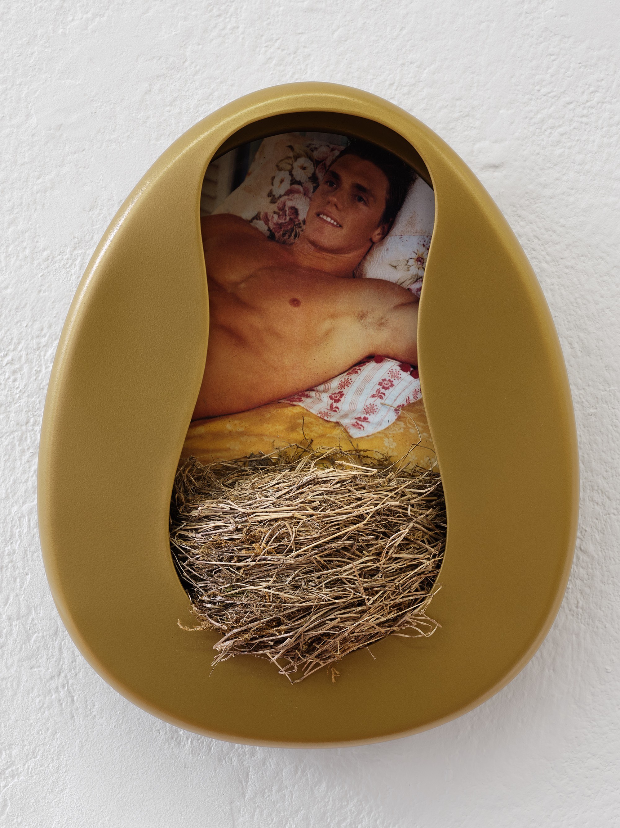 Billie Clarken, Your Future Awaits; Reification of the Afterlife, 2020/25, Bronze-plated bedpan, abandoned blackbird‘s nest, image from Abercrombie & Fitch Catalogue 2001, 35 x 28 x 13 cm © The artist and Galerie Brugger Photo: Juri Löchte