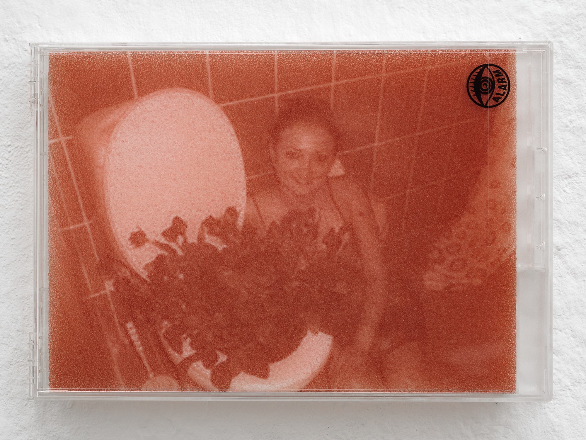 Billie Clarken, Pageantry Preclusions (Chewing Tongue series), 2026, UV print on foam, locked acrylic DVD security box, 14.8 × 21.5 × 2.2 cm © the artist and Galerie Brugger Photo: Juri Löchte