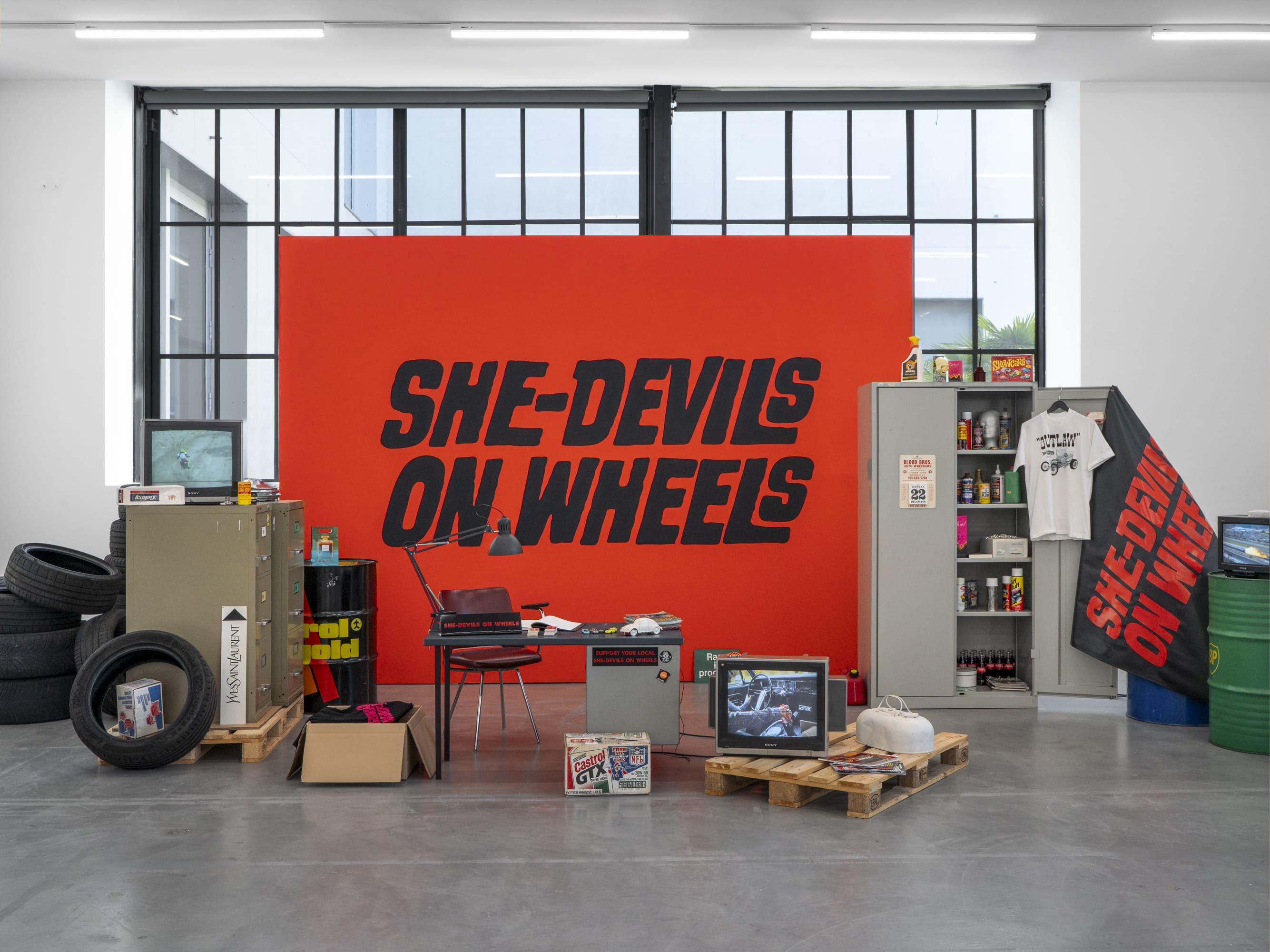 Exhibition view Sammlung &: Sylvie Fleury Shamiran Istifan, She-Devils on Wheels Angels on Heels, Migros Museum für Gegenwartskunst, 2026. Sylvie Fleury, She-Devils on Wheels – Headquarters, 1997, © Sylvie Fleury. Photo: Studio Stucky.
