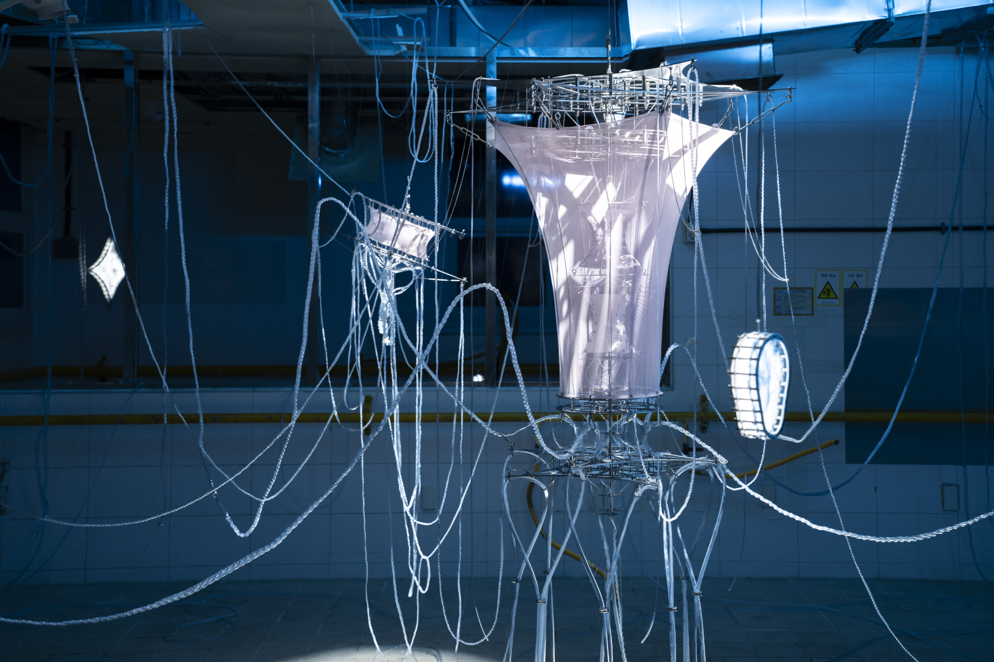 We Were Trembling as If in Cold Water, 2026, two-channel sound installation; fabric, stainless steel, PVC, LED, hose, water pump and air circulation system, dimensions variable. Commissioned by Busan Biennale Organizing Committee, 2026.